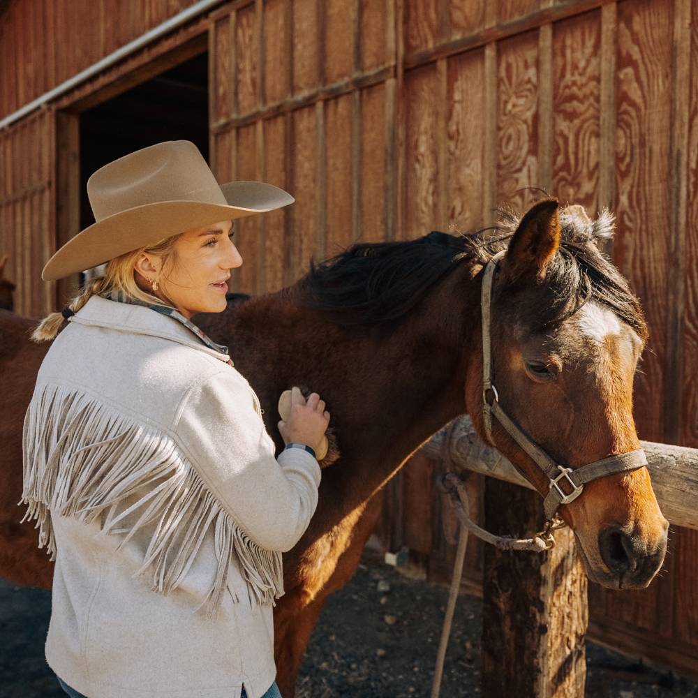 Woman grooming a horse wearing Buck Oak Brown Cowboy hat