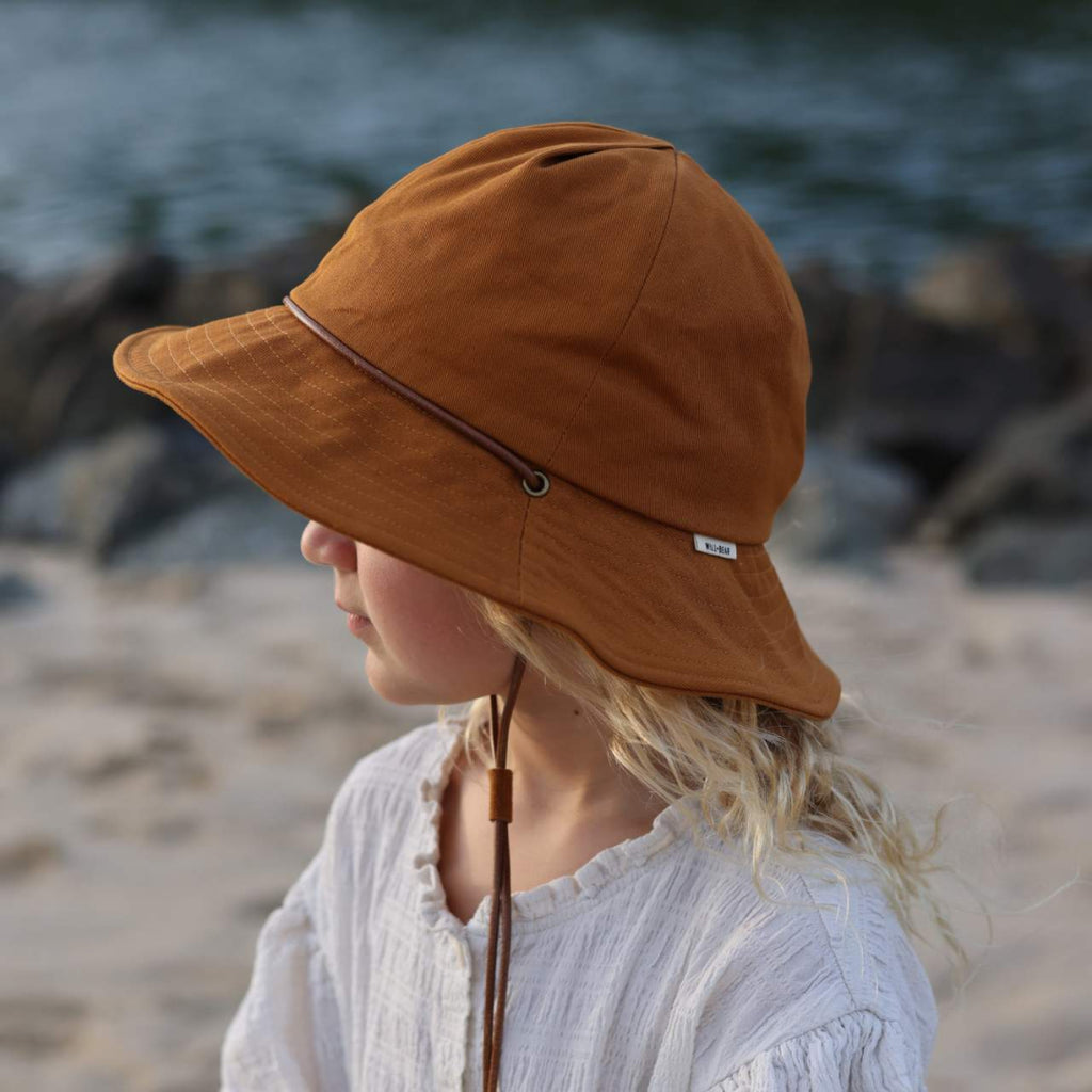 Little girl wearing orange bucket hat