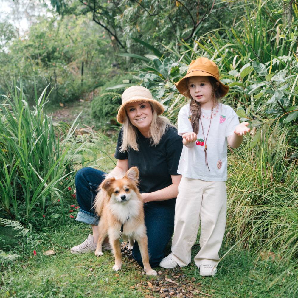 Mum and her daughter and dog wearing wide brim bucket hats going for a bush walk