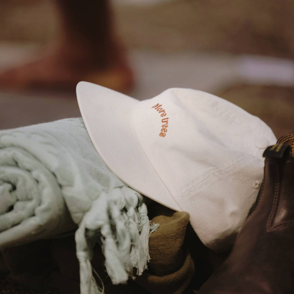 Riley Bone cap sitting on top of some beach towels