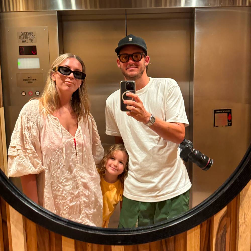 Young family taking a vacation selfie in a hotel mirror in Hawaii