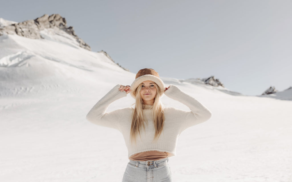 Women in the snow with wool bucket hat on