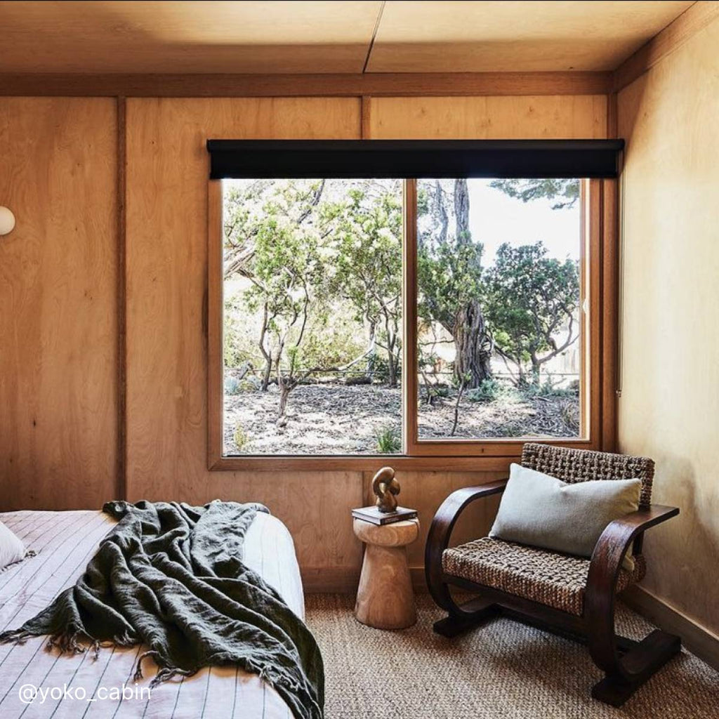 Sitting chair beside a window inside a rustic cabin