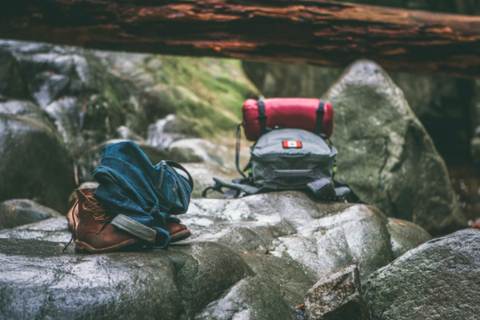 hiking backpacks sitting on rocks