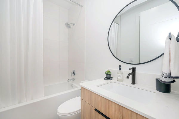 White Bathroom featuring a matte black vanity faucet and other matte black fixtures.