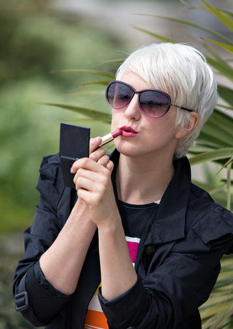 Woman applying lipstick