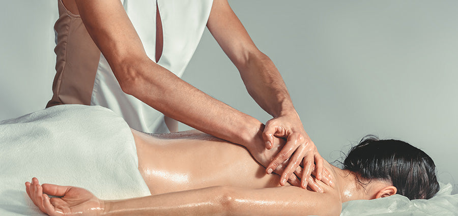woman getting a back massage with cbd massage oil. best massage oil with hemp-derived CBD products.