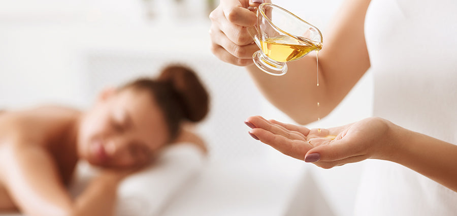 Massage therapist pouring CBD oil in her hand. 