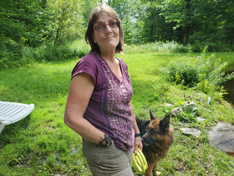 Abby and Kona at her pond in Fayston, Vt, wearing her ABD culture.