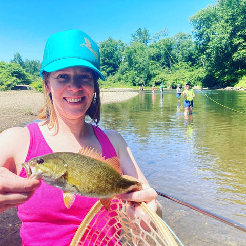 Amanda learning to fly fish in Stowe, VT. Wearing her ABD up-cycled rubber adventure jewelry.