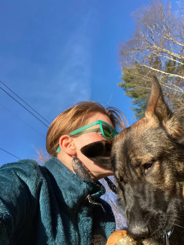 Amanda and her dog Lolly. Amanda is rocking the lori feather earring, an up-cycled rubber adventure jewelry.