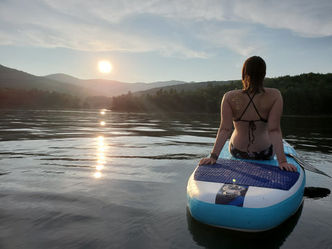 Amanda paddle boarding at the Waterbury Reservoir, wearing her waterproof, up-cycled rubber adventure jewelry.