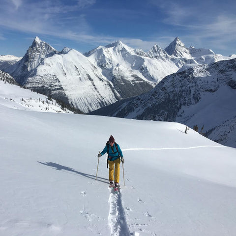 Keitha backcountry skiing in British Columbia, CA. Wearing her up-cycled rubber adventure jewelry, ABD Culture.