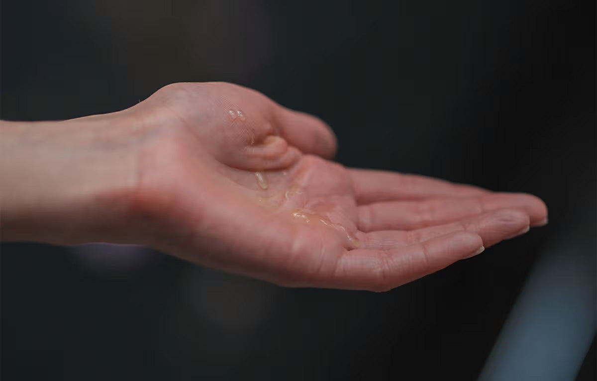 woman's hand with oil droplets in it