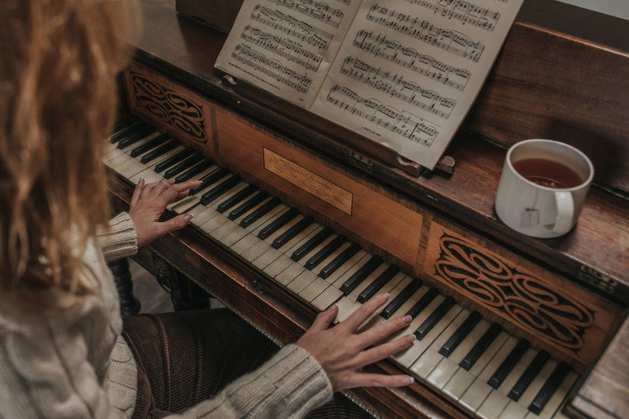 Girl playing the piano with a cup of tea in a Barton Croft mug