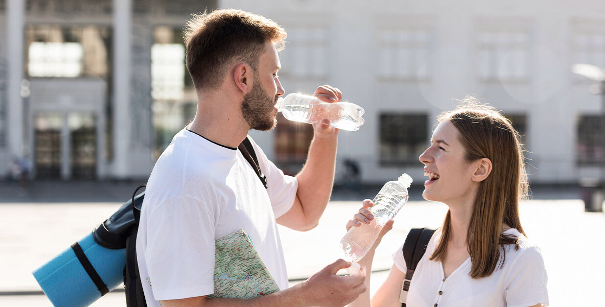 stay hydrated man and women drinking water from water bottle