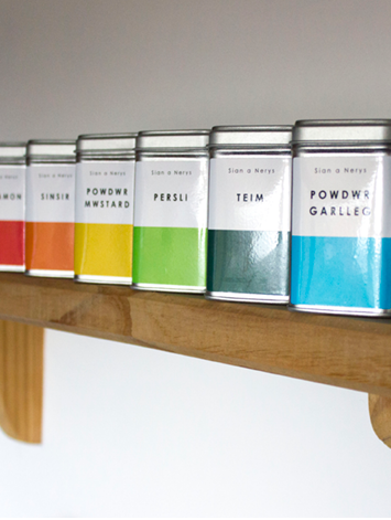 Sian a Nerys spice tins on a display shelf.