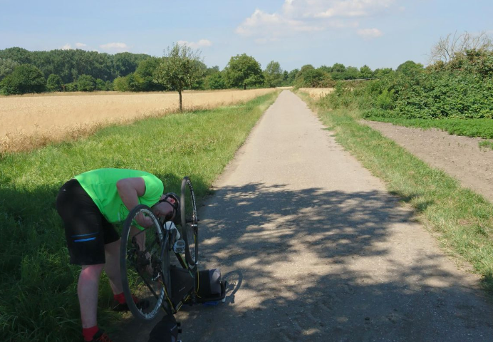 jon repairing his bike on a path