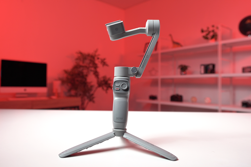 Gimbal placed on white desk with red background 