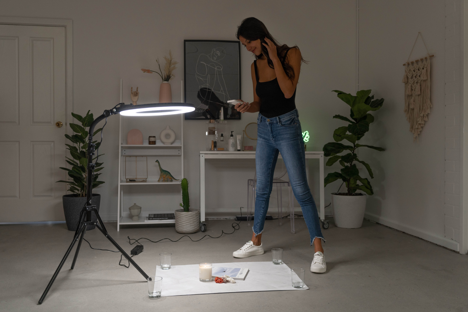 an image of a woman in her living room doing a flat lay photoshoot using her ring light.