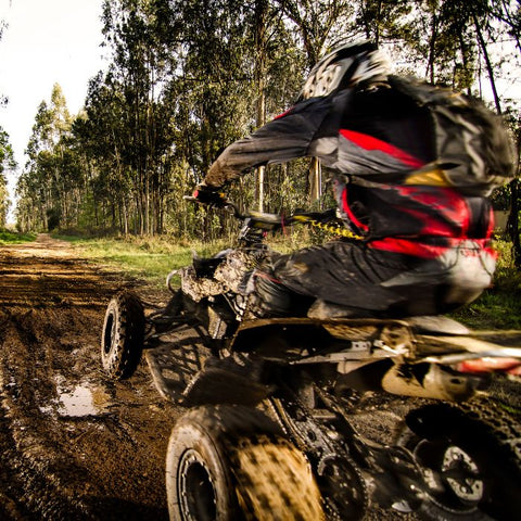 a teenager off-roading on their quad bike