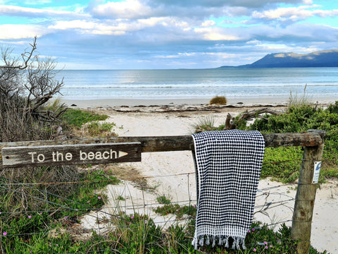 towel on a fence overlooking the beach