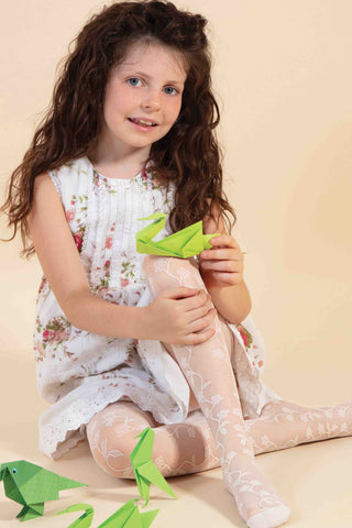 Young girl sitting, clapping her raised knee, wearing white sheer flower tights.