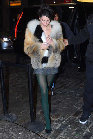 Kendall Jenna out on the town wearing a plaid top with an oversized jacket and green block colour tights.