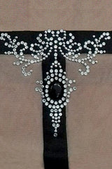 Close up sparkling crystals on black tattoo effect motif to form pendant style decoration