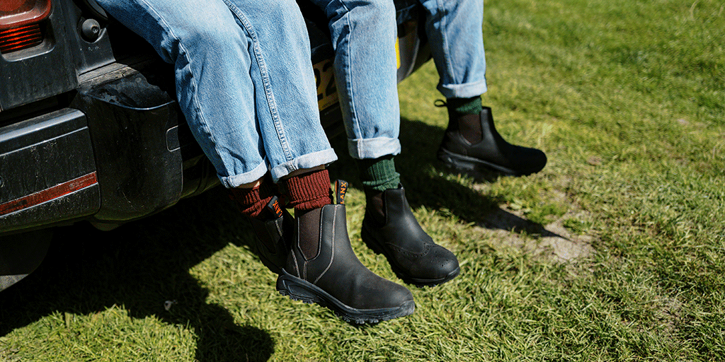 A man and a woman sat on a truck wearing the new LANX 365 outdoor boots