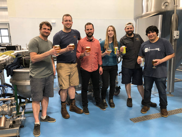 The True North Ale Company brewery staff with glasses of the winning batch of Vincianne.