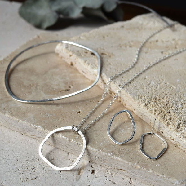 collection of ethical jewellery on natural stone background