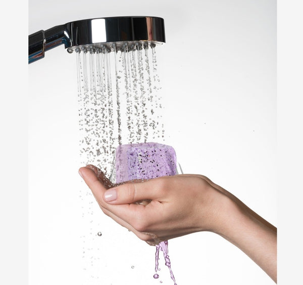 Shower steamer in hand with water
