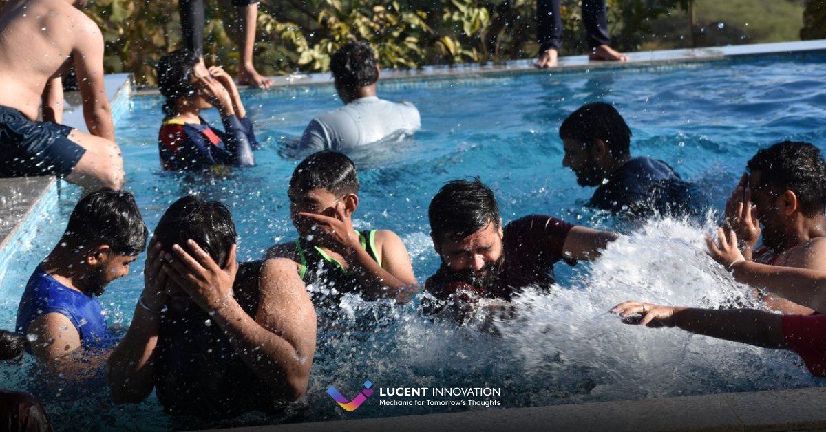 Lucent innovation team members splashin water in swimming pool 