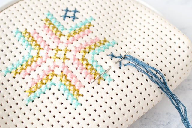 How to embellish a faux leather Target bag with cross stitching