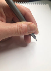 Pen held at a slight angle.