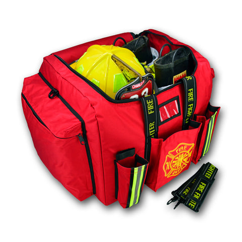 A red Lightning X Deluxe Step-In Turnout Gear Bag, open and stocked with firefighter equipment including a yellow helmet, boots, and visible pockets holding various gear. The bag features reflective striping, heavy-duty construction, and embroidered logos for fire department identification