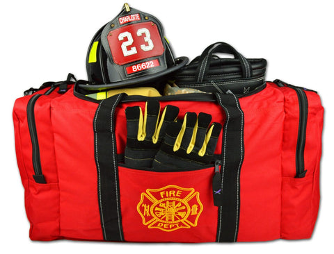 The image shows a red firefighter gear bag with reflective strips, multiple compartments, and a yellow helmet. It's marked with "FIRE DEPT" and includes a name tag.