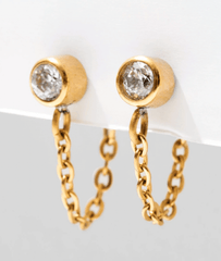 gold bezel set stud earrings with titanium hanging gold chain on a white background