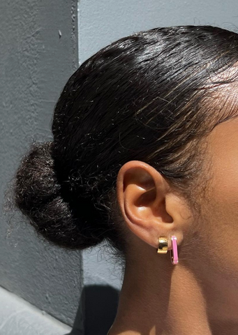 girl wearing hypoallergenic pink enamel hoop earrings