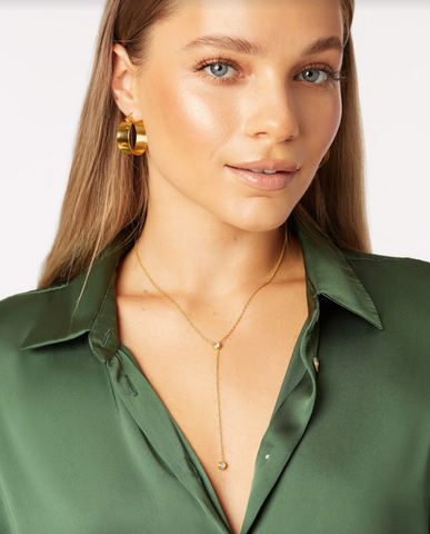 girl wearing wide flat hypoallergenic hoop earrings