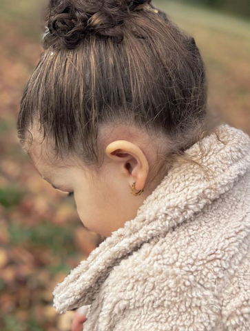 little girl wearing hypoallergenic cute hoop earrings for kids