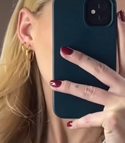 girl wearing hypoallergenic gold endless hoop earrings with red nails for for fall