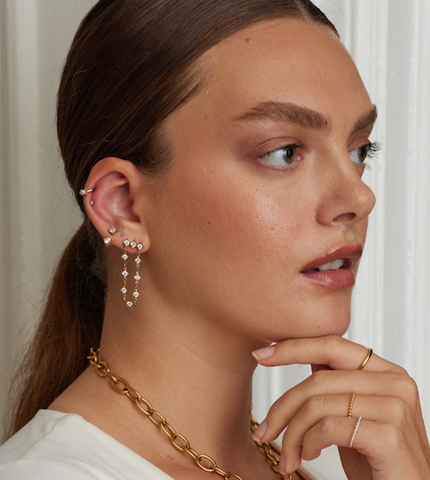 girl wearing hypoallergenic triple crystal stud earrings with crystal drop chain