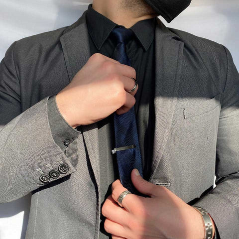Man in suit wearing jewelry