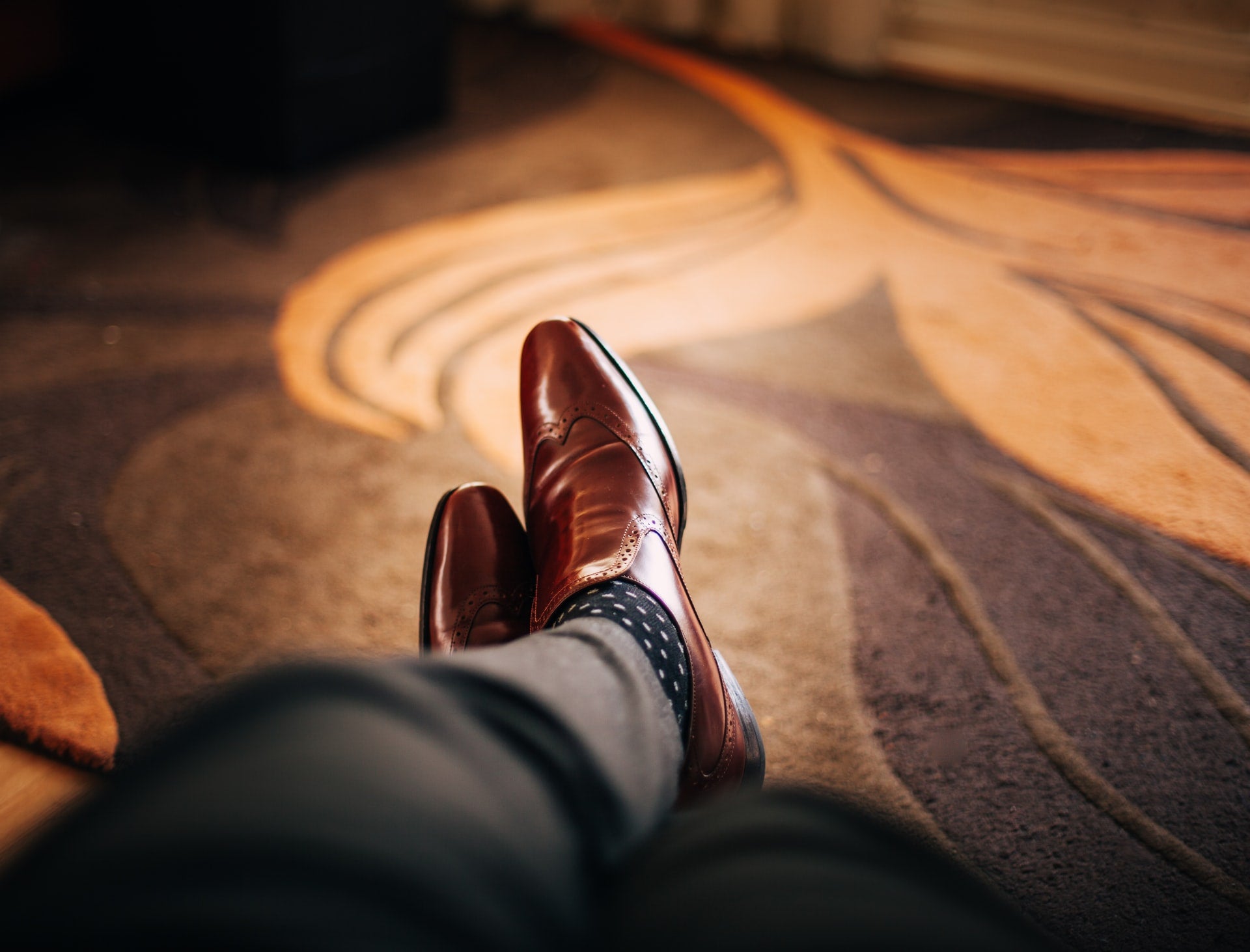 A POV view of a man’s dress shoes