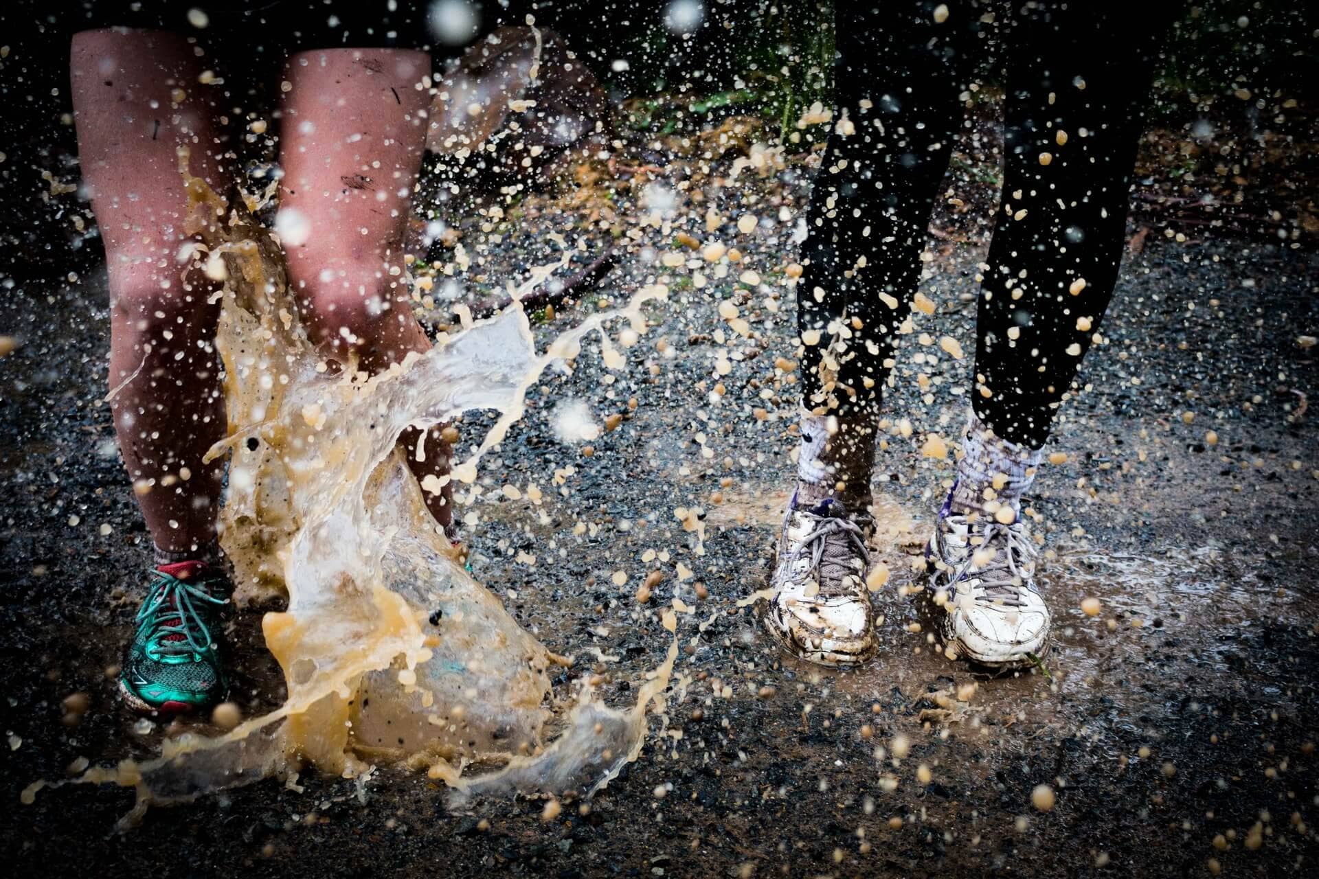 Two people splashing the mud