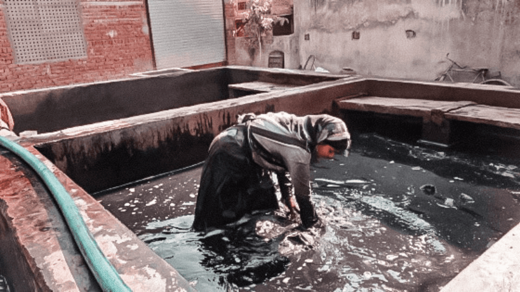 fabric being washed by an artisan after block printing 