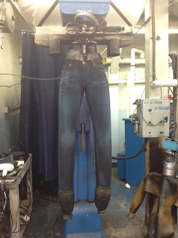 hand sanding blue jeans