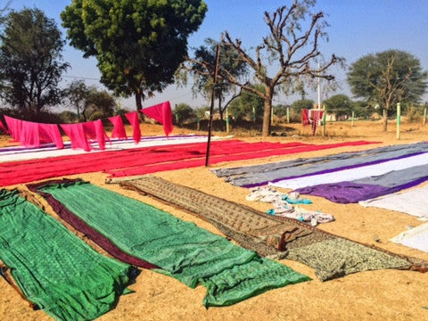 fabric drying on the ground in the sun